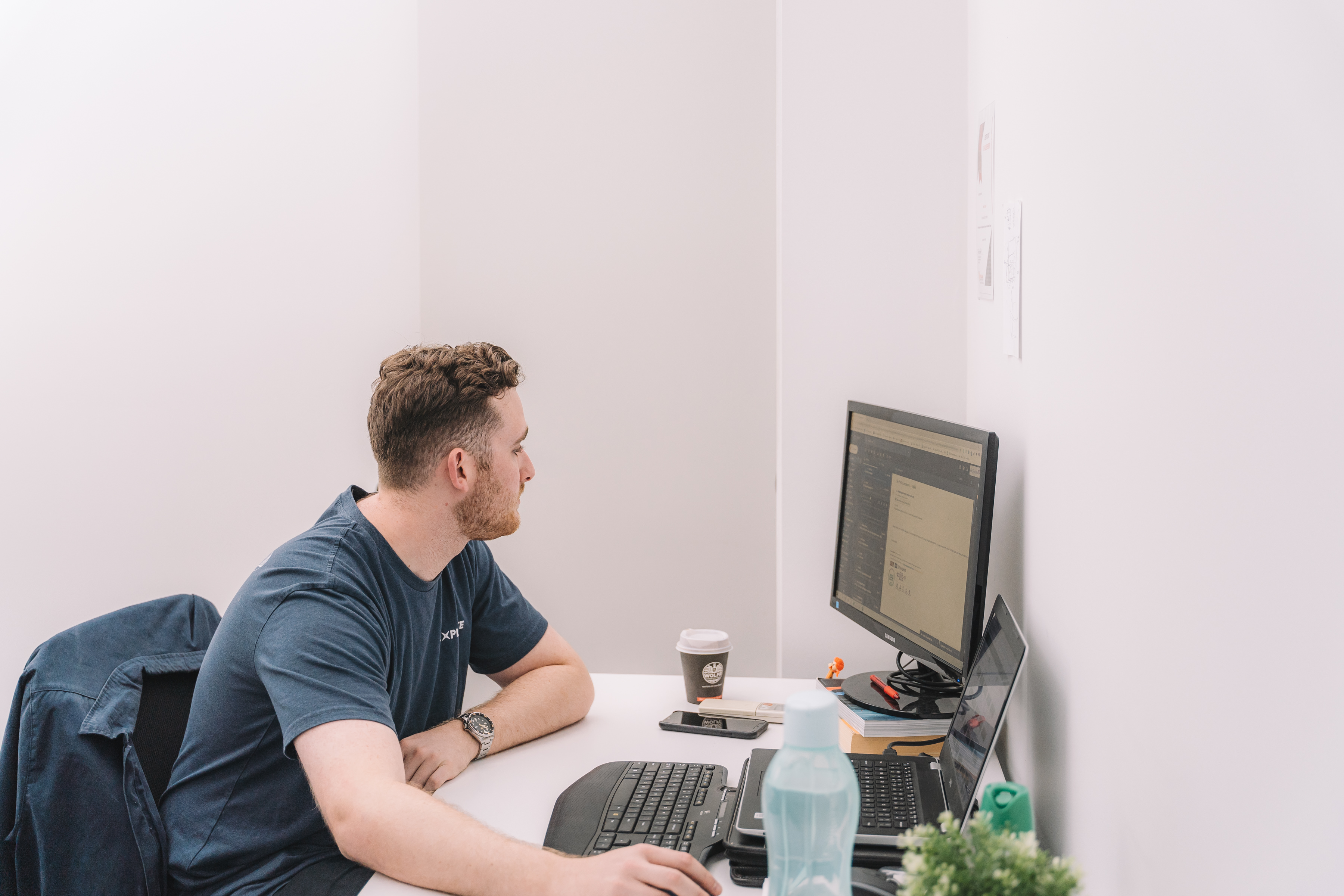 An Explorate operator working at a desktop computer during workflow research