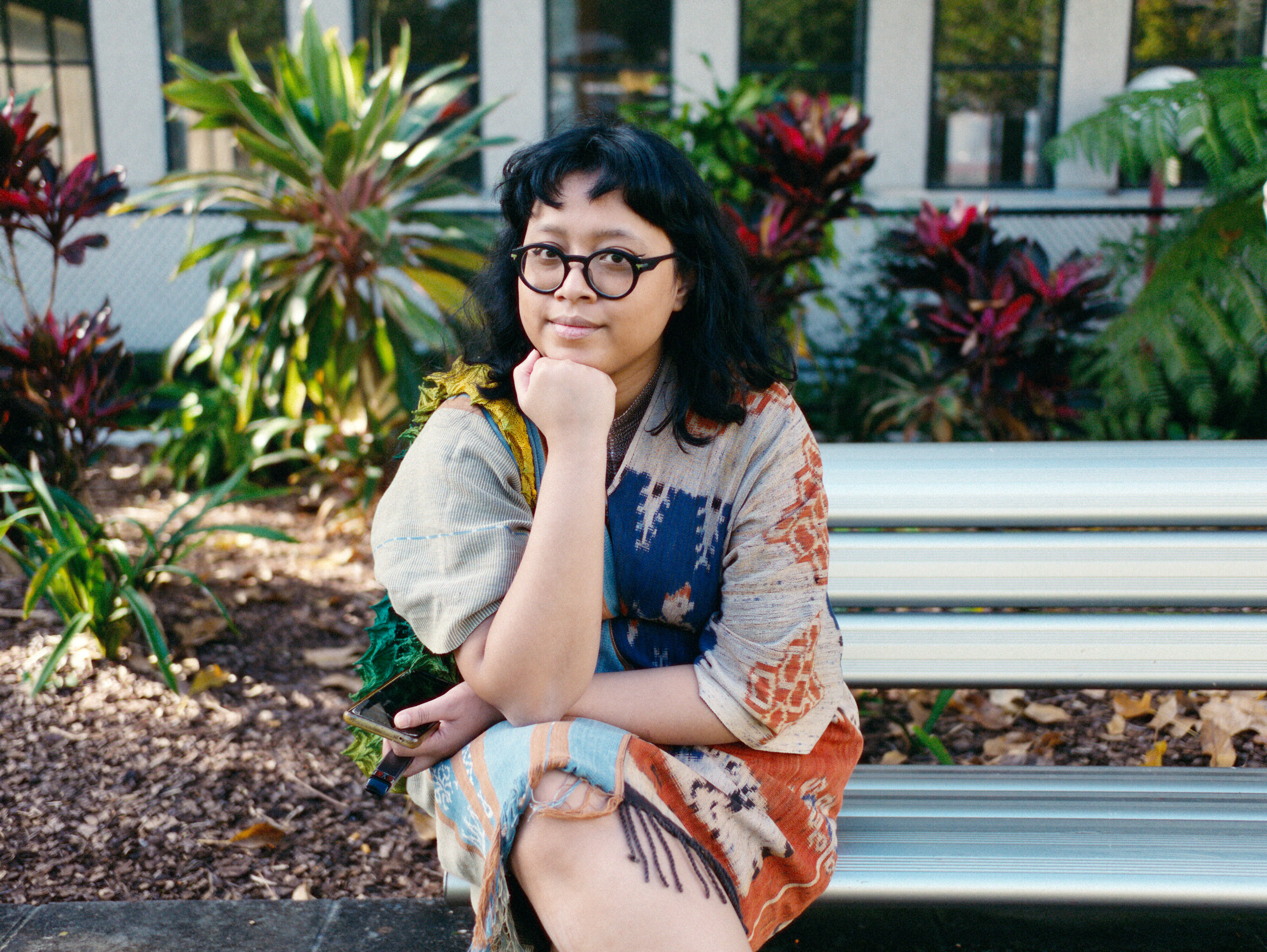 Meta Andrini Utari sitting in a garden